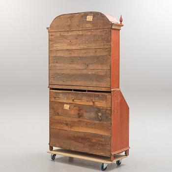 An end of the 18th century cabinet with clock.