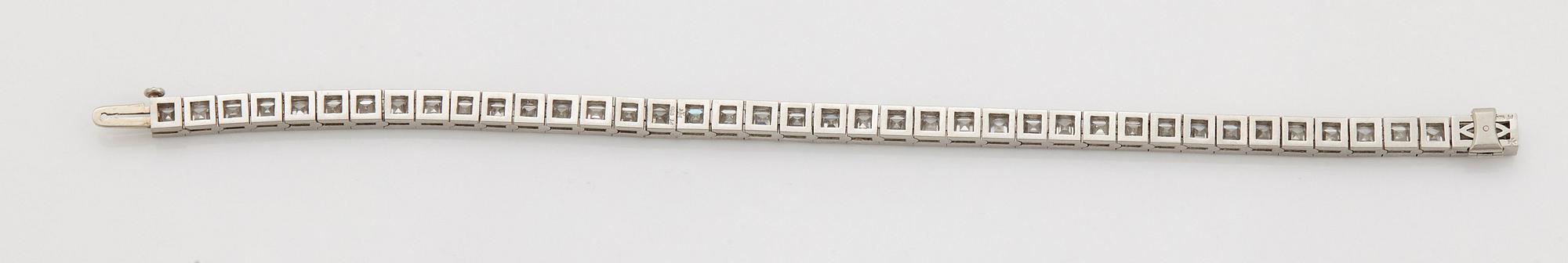 A platinum bracelet set with carré cut diamonds.