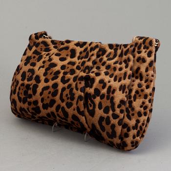 A leopard patterned ponyhair handbag by Christian Louboutin.