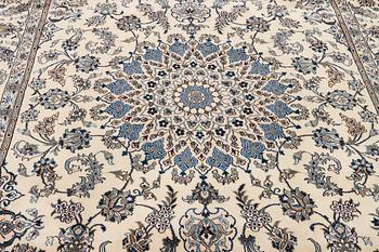 A Nain, part silk carpet, c. 337 x 244 cm.