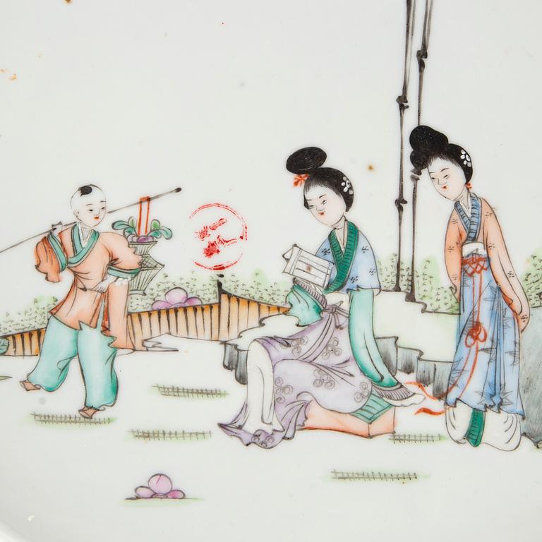 A set of two Chinese porcelain trays decorated with elegant ladies and children, 20th century.