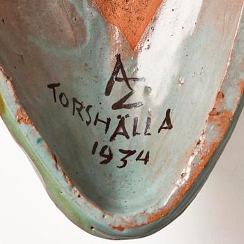 Allan Ebeling, a glazed earthenware wall sculpture of a masque, Torshälla 1934.