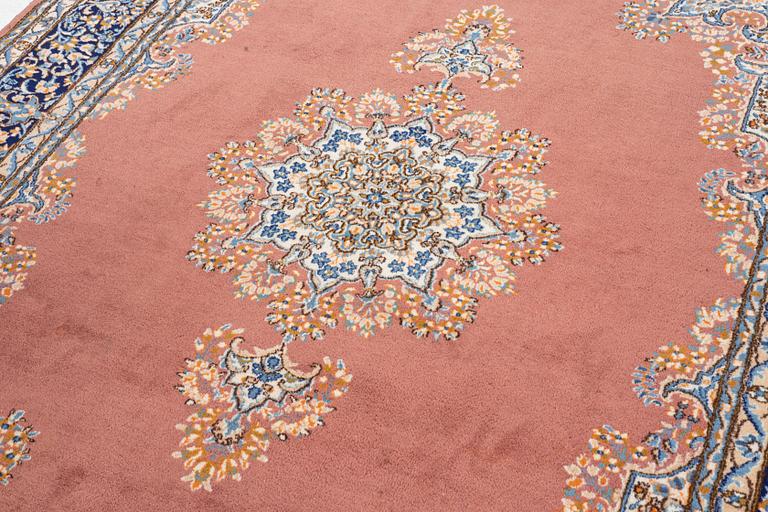 An carpet, possibly a Kerman, c. 310 x 230 cm.