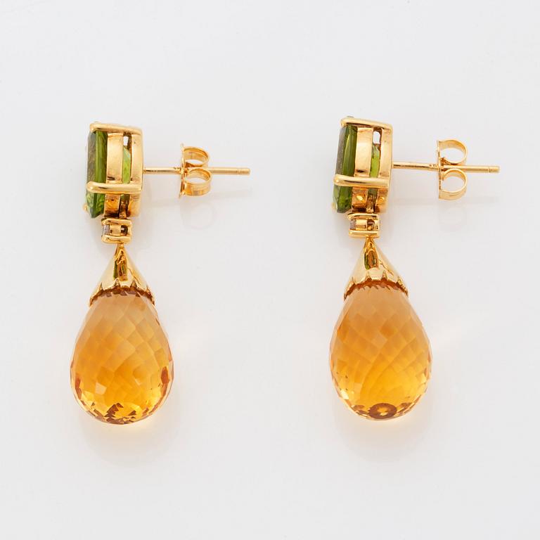 A pair of 18K gold earrings set with faceted peridots and with briolette-cut citrines.