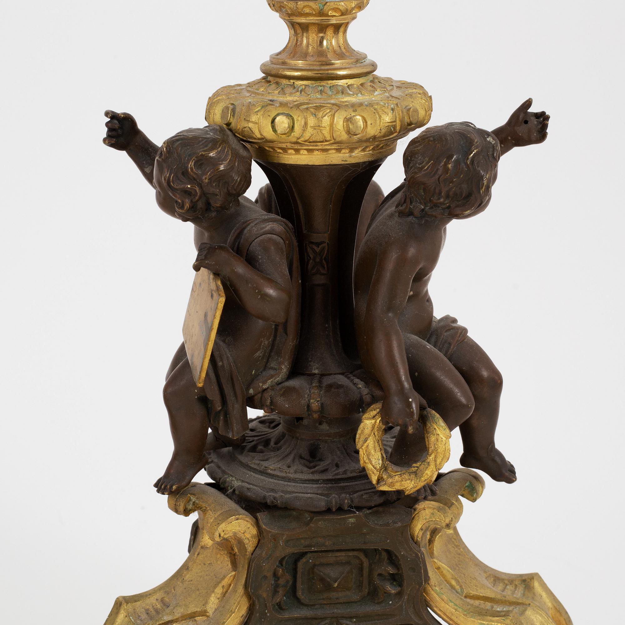 A pair of patinated bronze and ormolu neo-renaissance six-light candelabra, later part of the 19th Century.