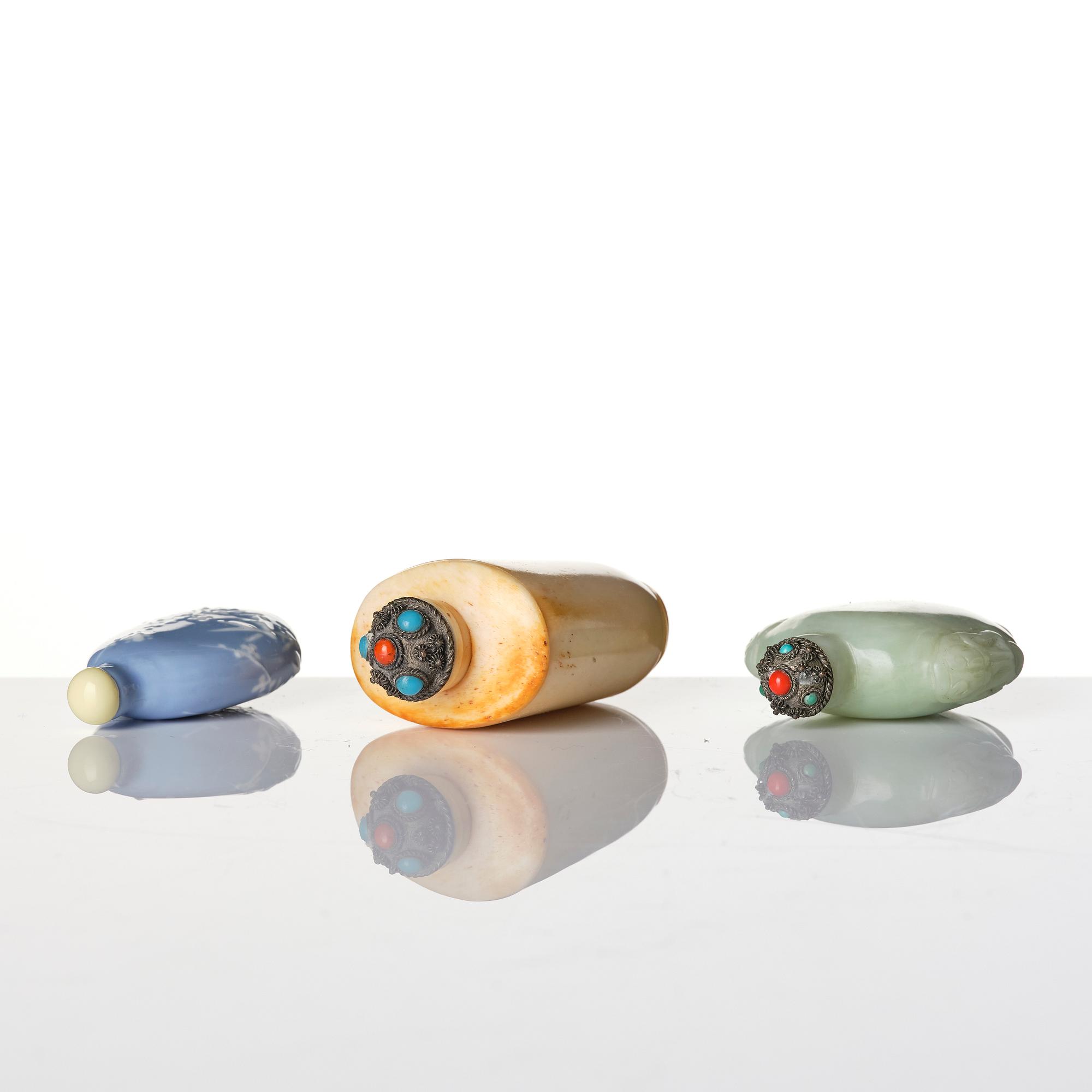 A group of three Chinese snuffbottles, stone, glass and bone, late Qing dynasty / around 1900.