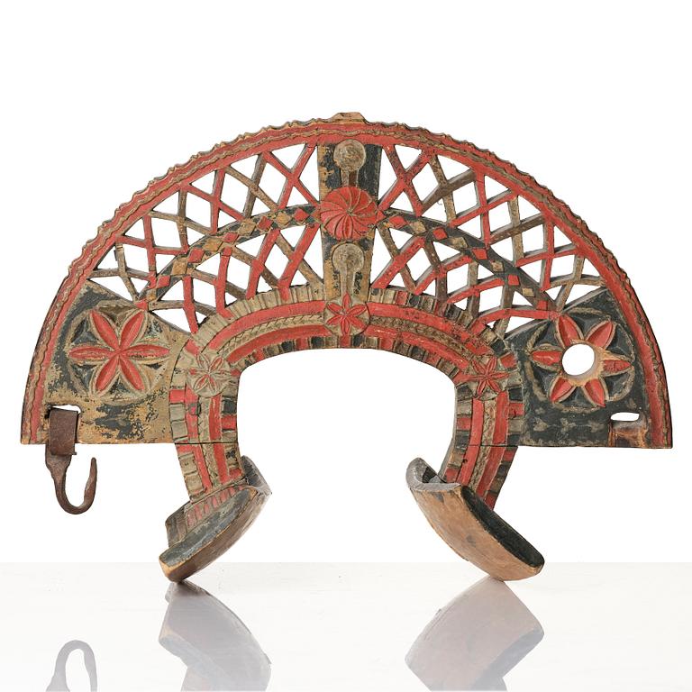 A Swedish folk art carved and polychrome-painted part horse harness, Uppland, dated 1774.
