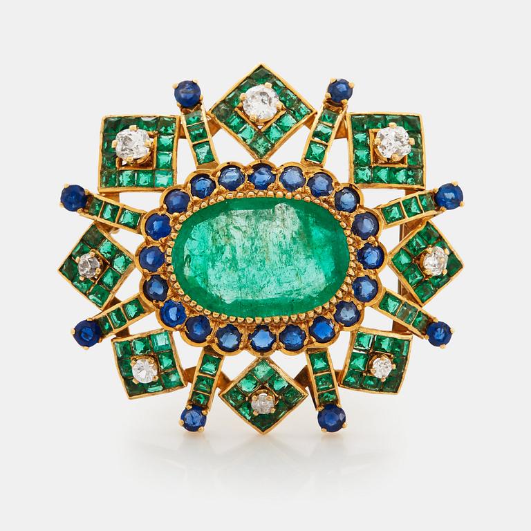 An 18K gold brooch set with an oval emerald and old cut diamonds.