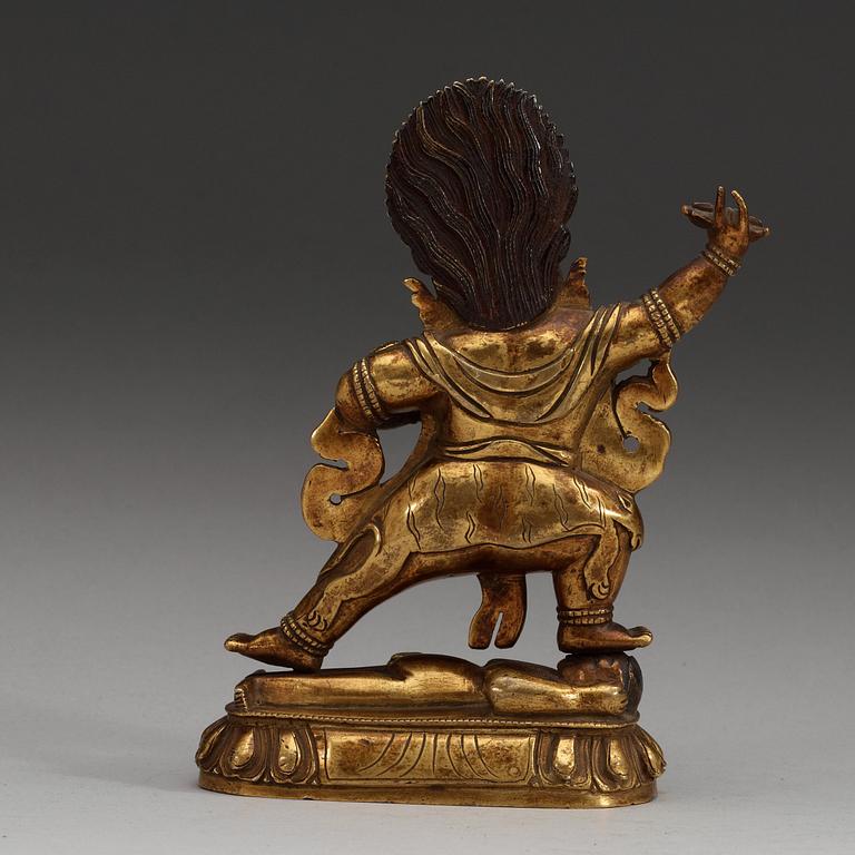A Sinotibetan gilt bronze figure of a Dharmapala, Qing dynasty, 19th Century.