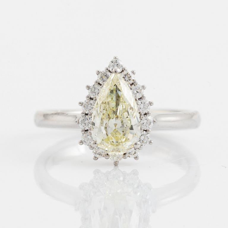 An 18K white gold ring set with  a pear brilliant-cut diamond.