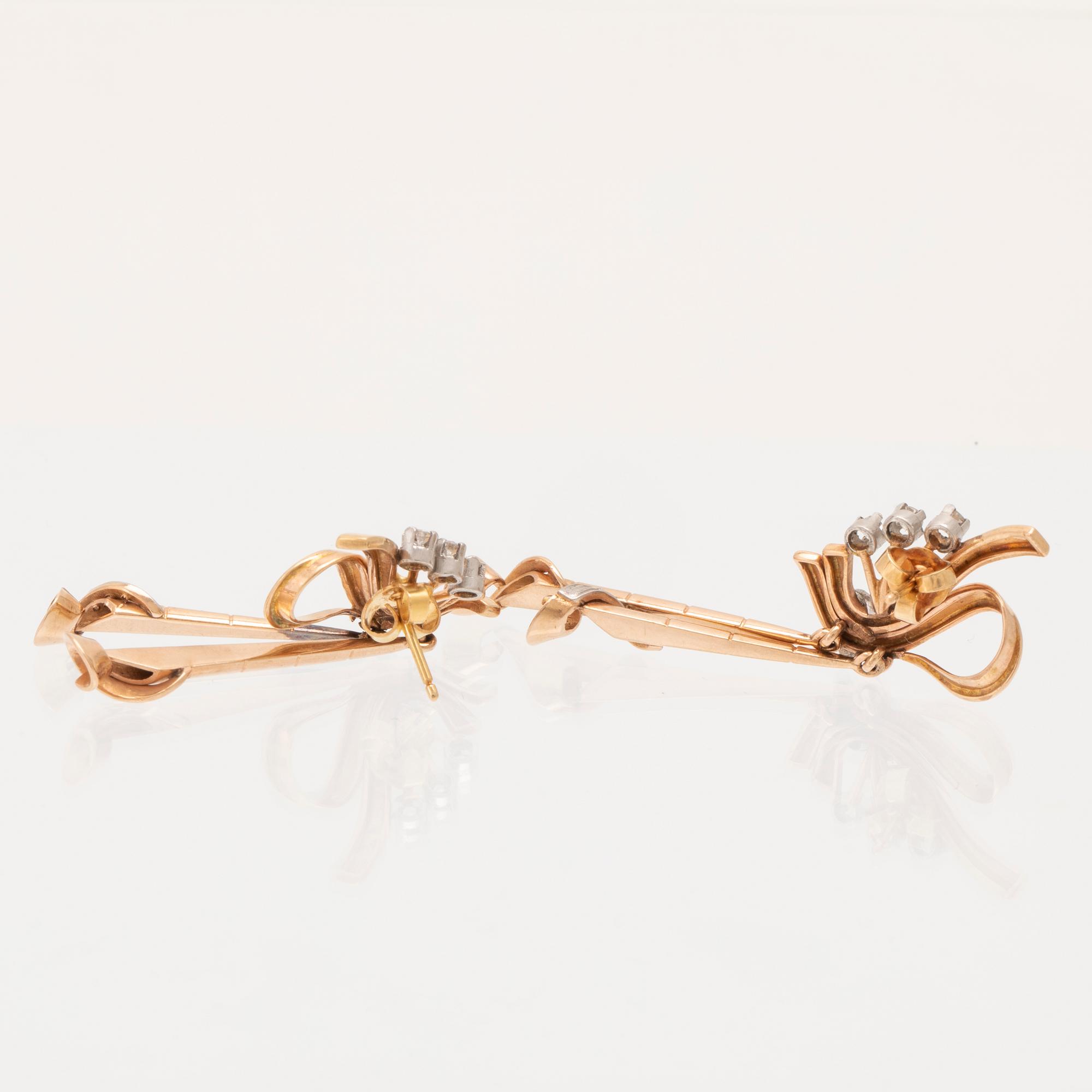 A pair of 18K white and red gold earrings set with single cut diamonds.