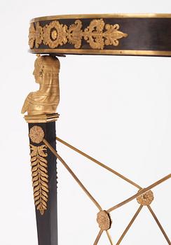 A French Empire-style gilt and patinated bronze  gueridon, later part of the 19th century.