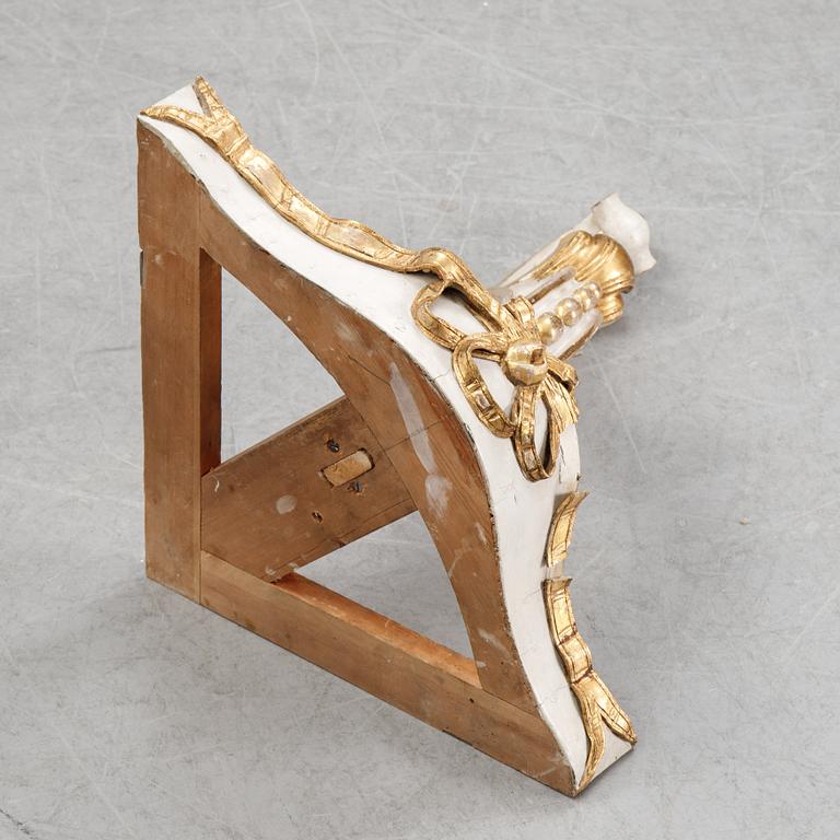 A samll console table for a corner with a wooden top.