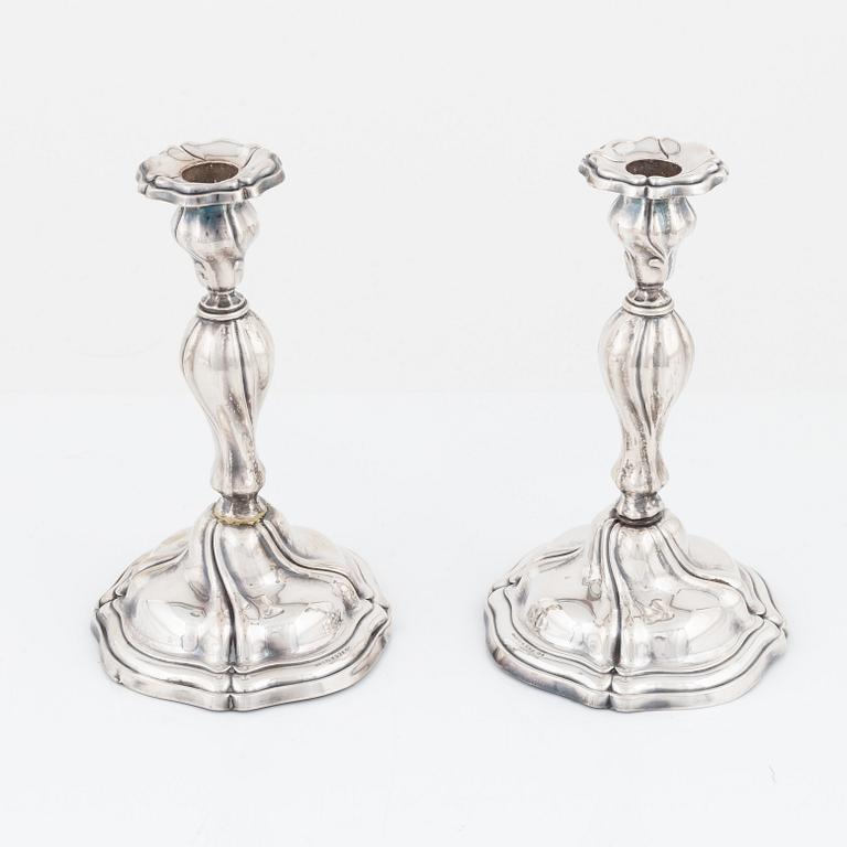 A pair of Rococo style silver candlesticks, bearing Swedish import marks, first half of the 20th Century.