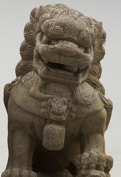 A pair of stone figures of Buddhist Lions on stands, late Qing dynasty / early 20th century..