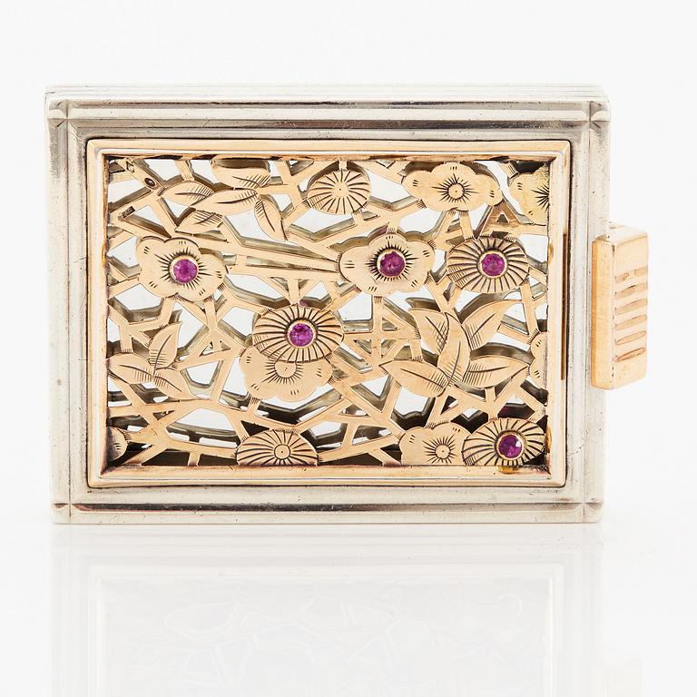 A Boucheron vanity case in silver set with faceted rubies.