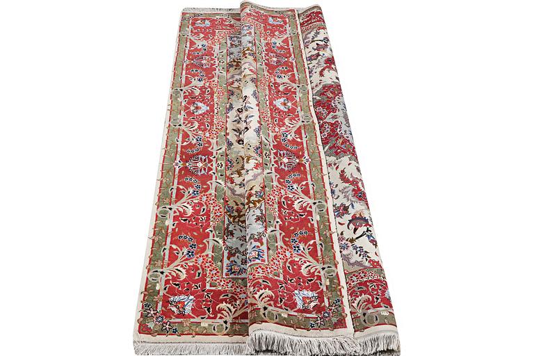 A Tabriz carpet, part silk, 50 raj, c. 204 x 154 cm.