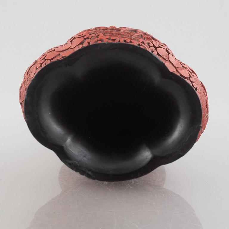 A red laquer vase, early 20th century.