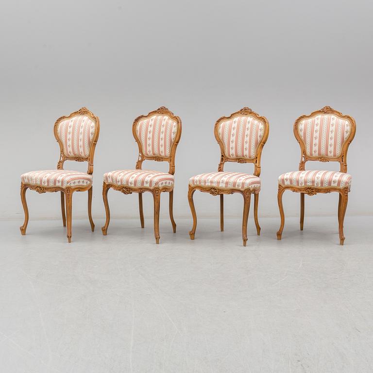 An end of the 19th Century rococo style walnut sofa with four chairs, two armchairs and a table.