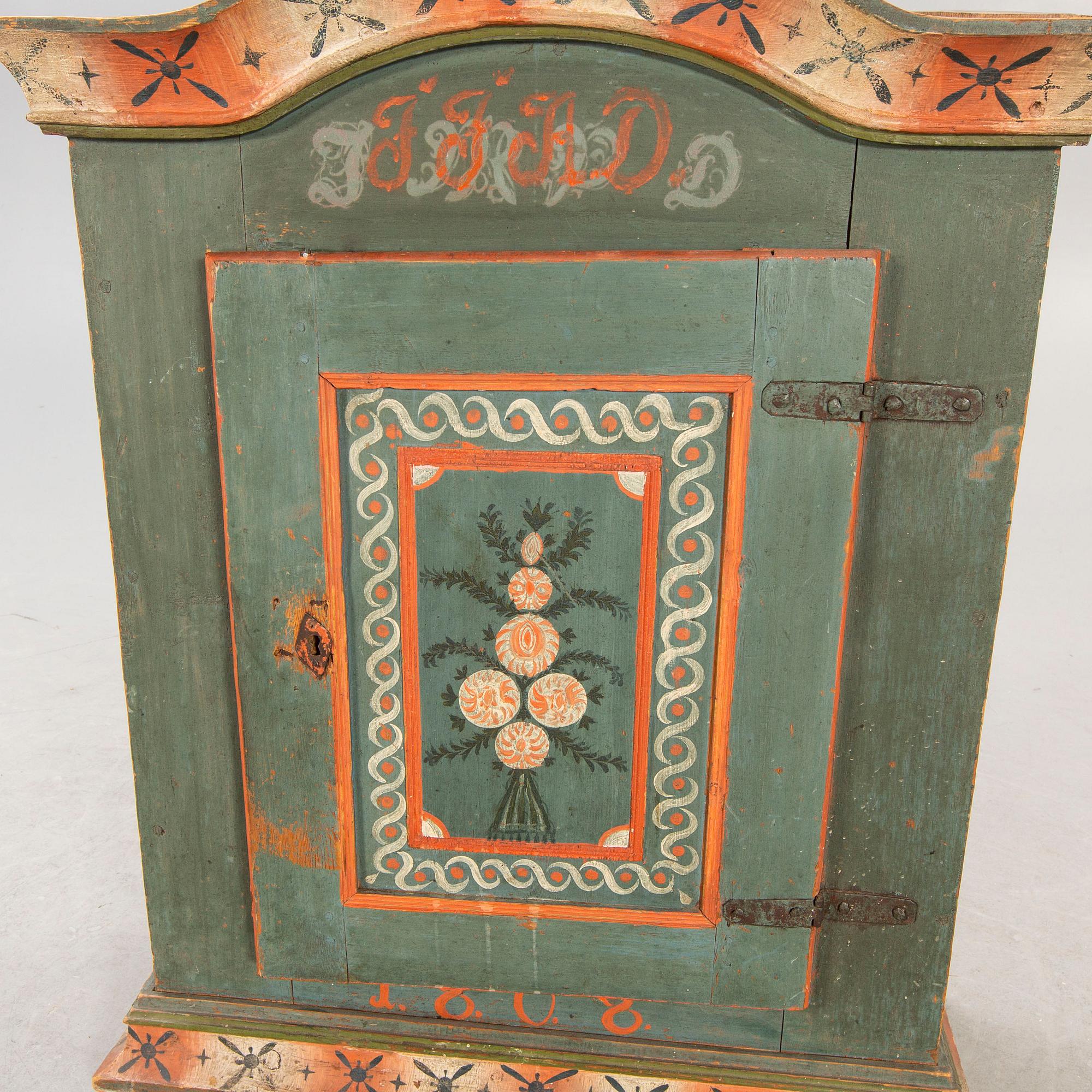 A painted Swedish wall cabinet dated 1808.