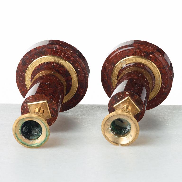 Two matched of 19th century Empire-style porphyry  candlesticks.