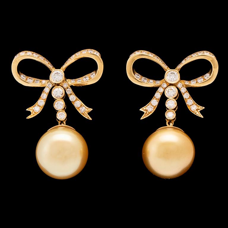 A pair of 18K gold earrings set with round brilliant-cut diamonds and cultured pearls.