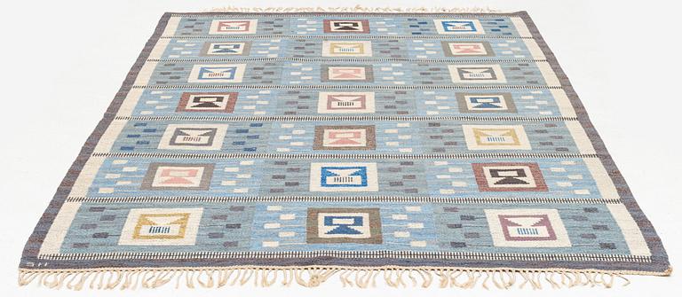 Edna Martin, a carpet, 'Flickorna i fönstret', flat weave, c 295 x 202 cm, signed SH.