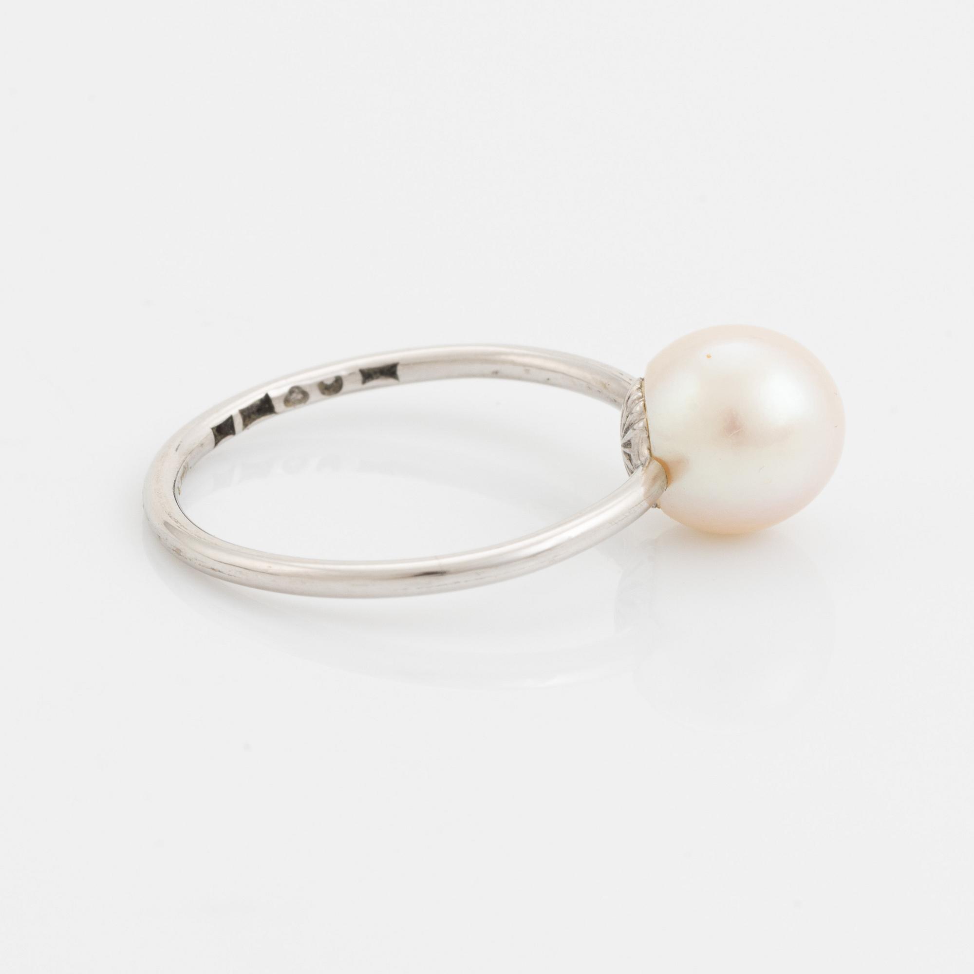 White gold earrings and ring with pearl and white stones.