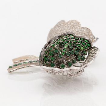 A tsavorite garnet and brilliant cut diamond clip brooch with floral motif.