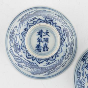 a pair of blue and white cups and three dishes, China, late Qing dynasty.