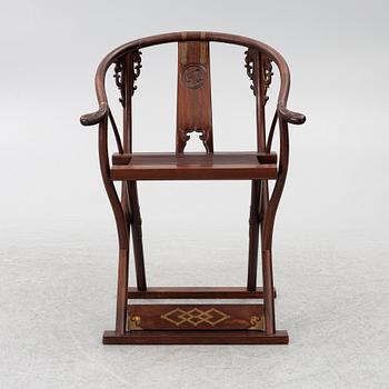 A Chinese hardwood folding chair, 20th century.
