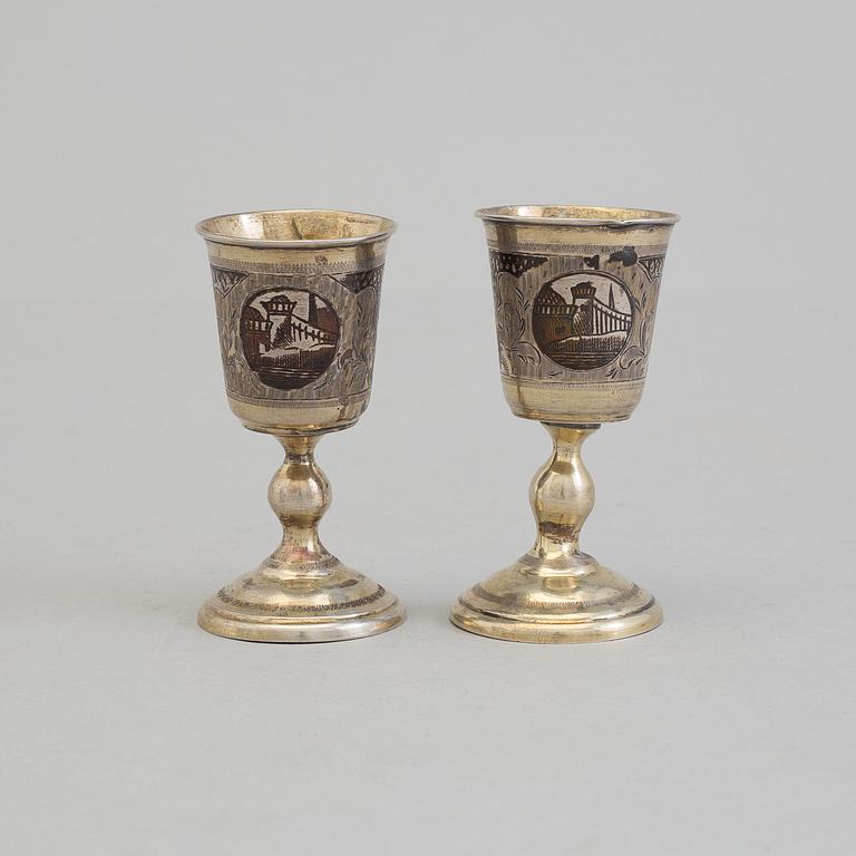 A pair of Russian 19th century parcel-gilt niello footed vodka cups, makers mark cyrillic "МД" (MD).