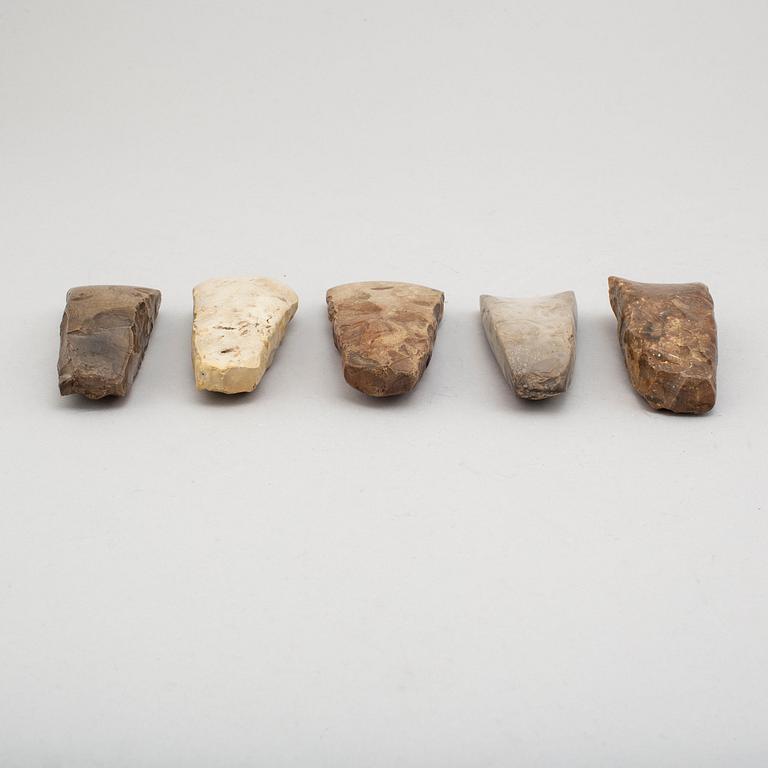 Five neolithic flint axes.