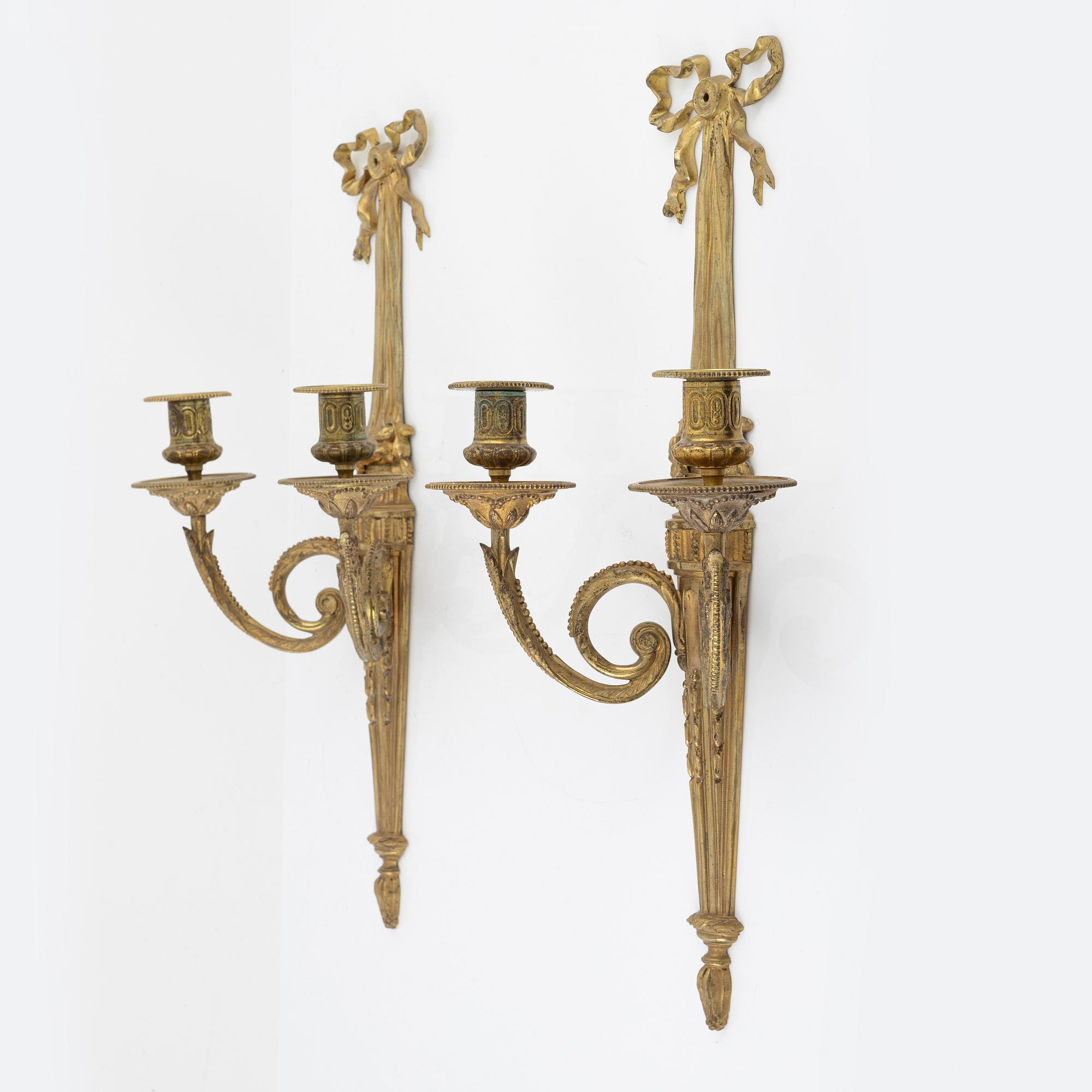 A pair of gilt brass wall sconces, Louis XVI-style, early 20th century.