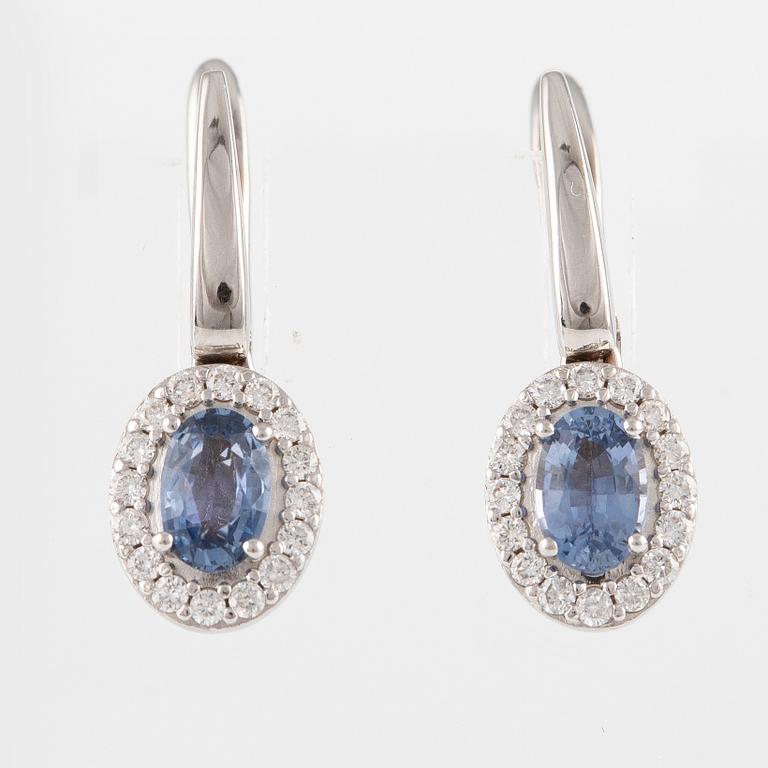 A pair of 14K gold earrings with faceted sapphires and round brilliant-cut diamonds.