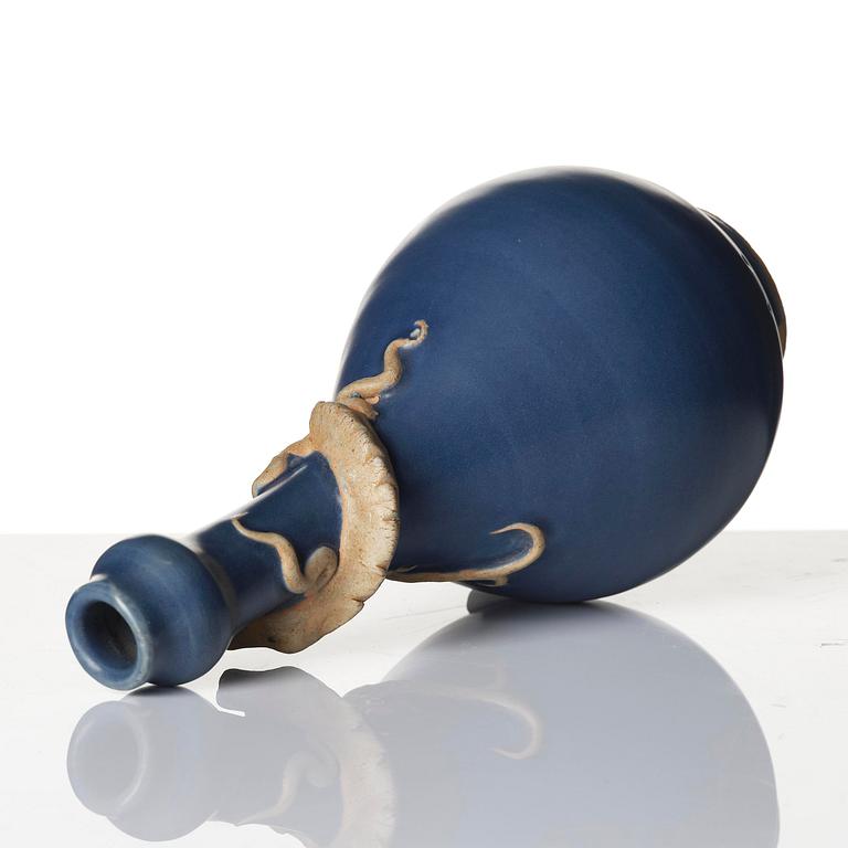 A blue glazed vase with a dragon in relief, late Ming dynasty/early Qing dynasty.