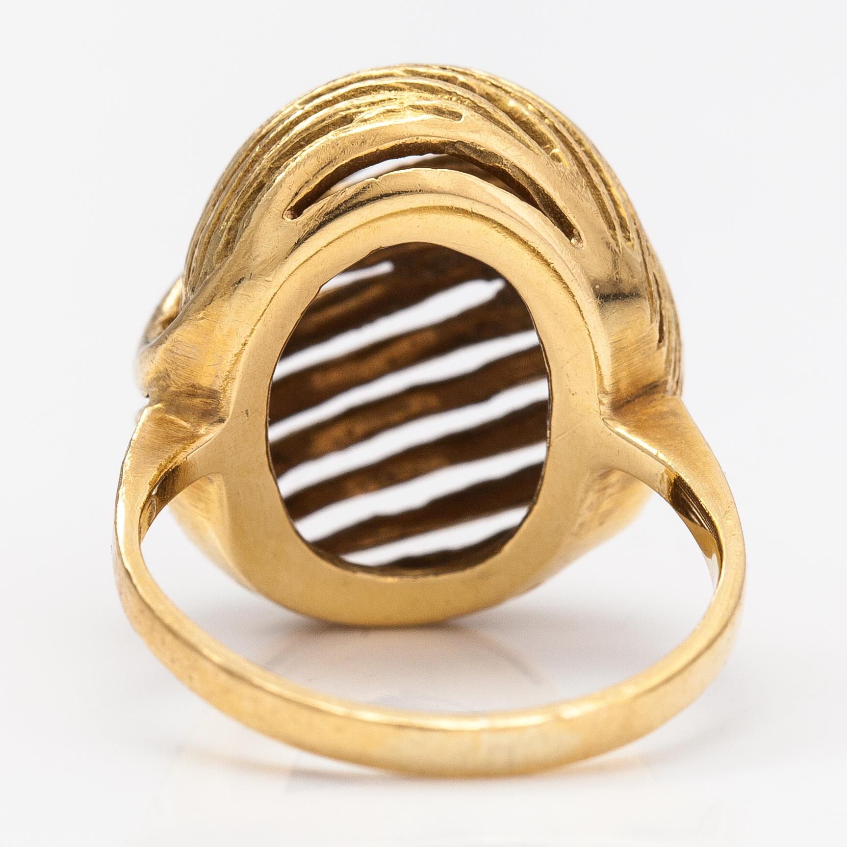 A pair of earrings and a ring made of 14K gold.