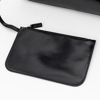 Gucci, a black, patent leather handbag.