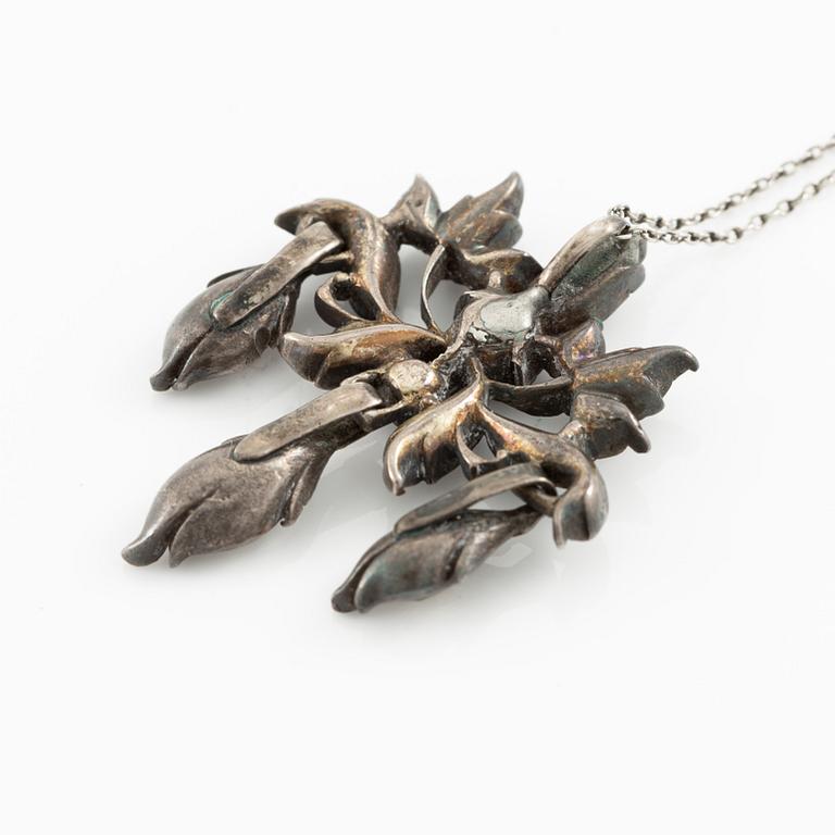 A brooch, a brooch pin, and a pendant, likely 19th century.