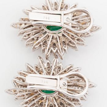 A pair of 18K white gold earrings set with faceted emeralds.