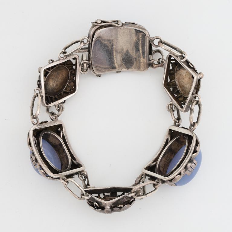 Bracelet, silver and cabochonslipade blue chalcedony, Gussi Smycken AB, Malmö, 1951.