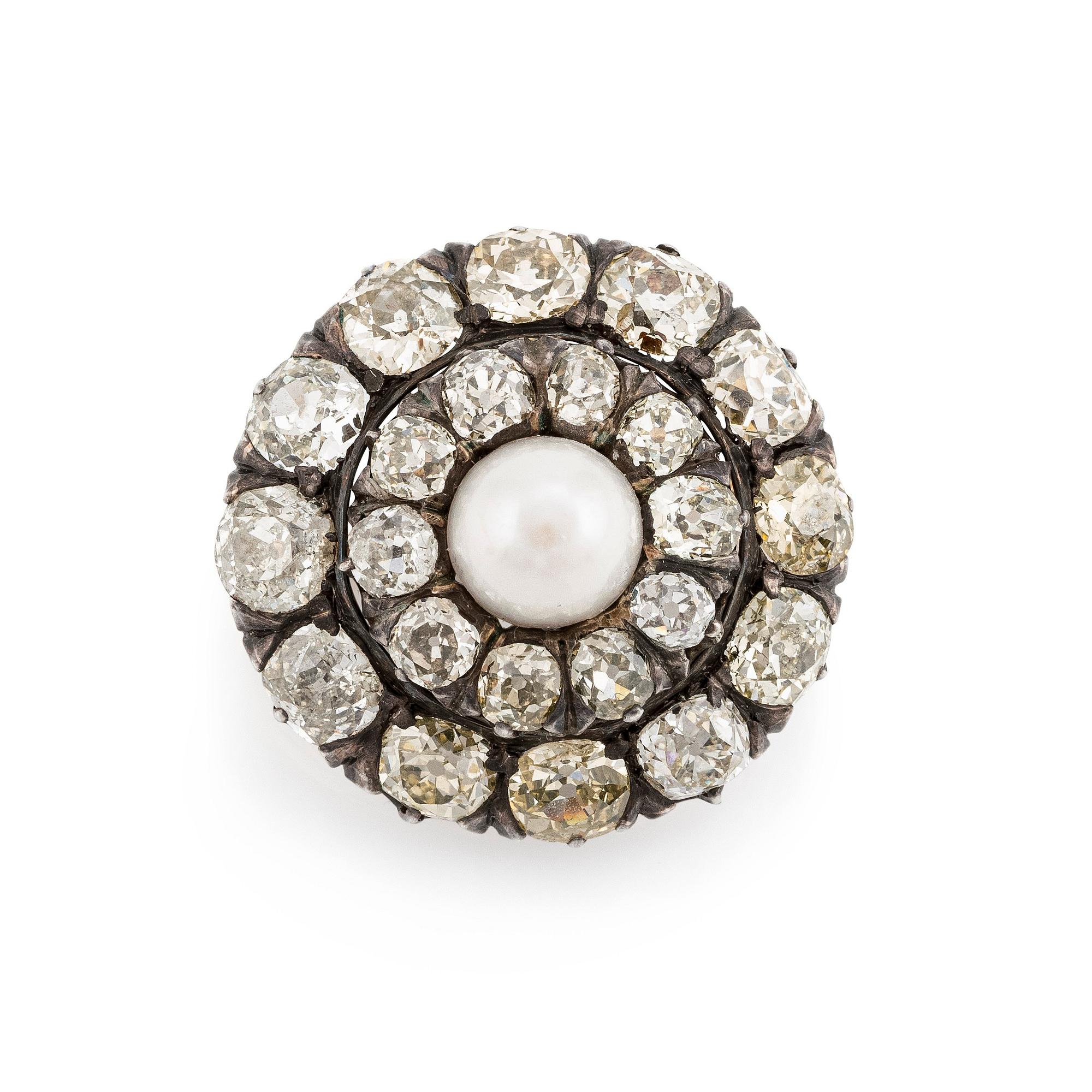 A silver and gold brooch, with cushion-cut diamonds and a pearl.