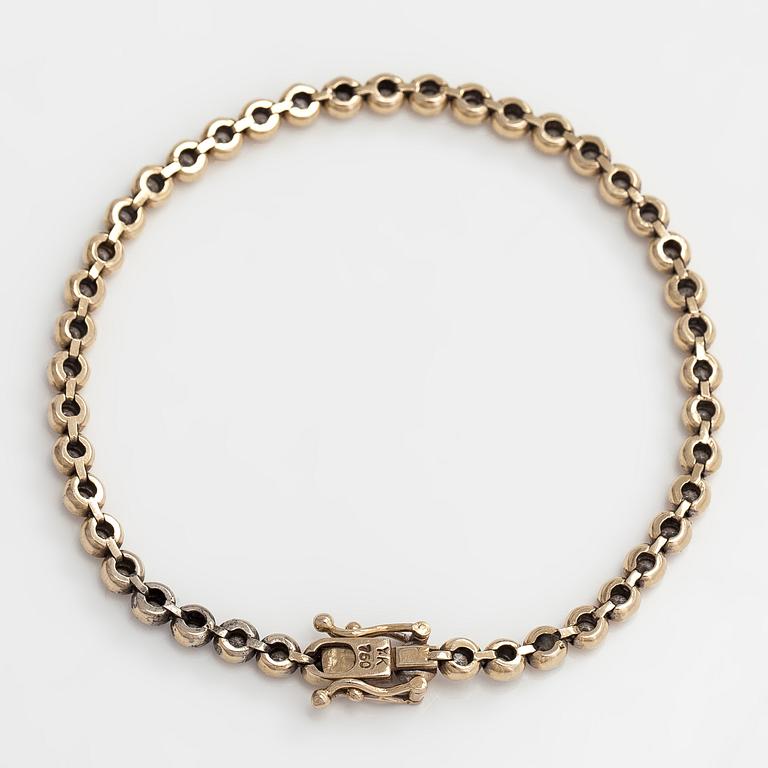 Tennisrannekoru, 18K kultaa ja timantteja yhteensä noin 0.78 ct.