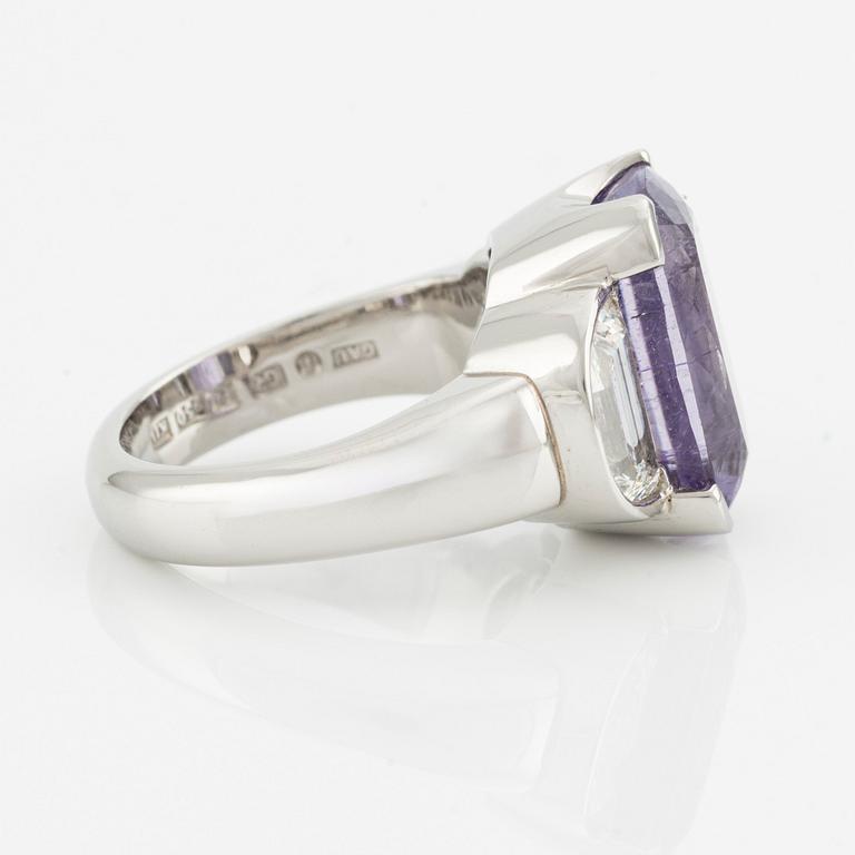 A Gaudy platinum ring with a faceted purple tourmaline and step-cut diamonds.