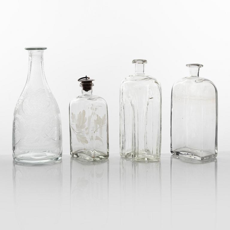 A set of three glass bottles and one decanter, 19th Century.