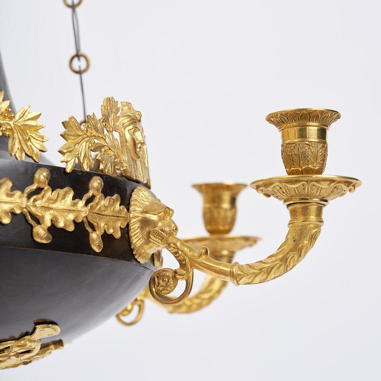A patinated and ormolu six-light Empire chandelier, Stockholm, first part 19th century.