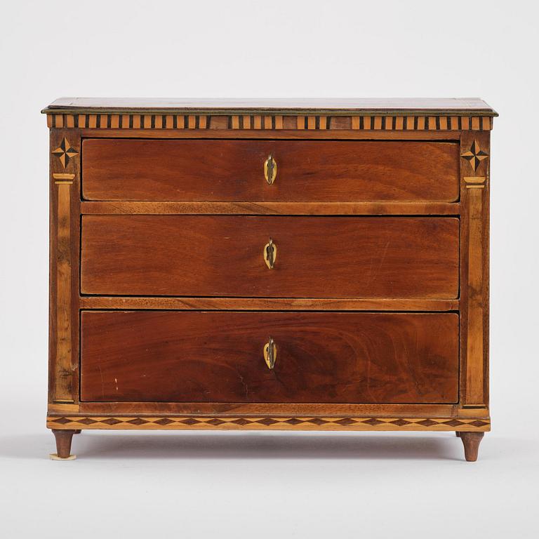 A Northern European mahogany miniature commode, early 19th century.