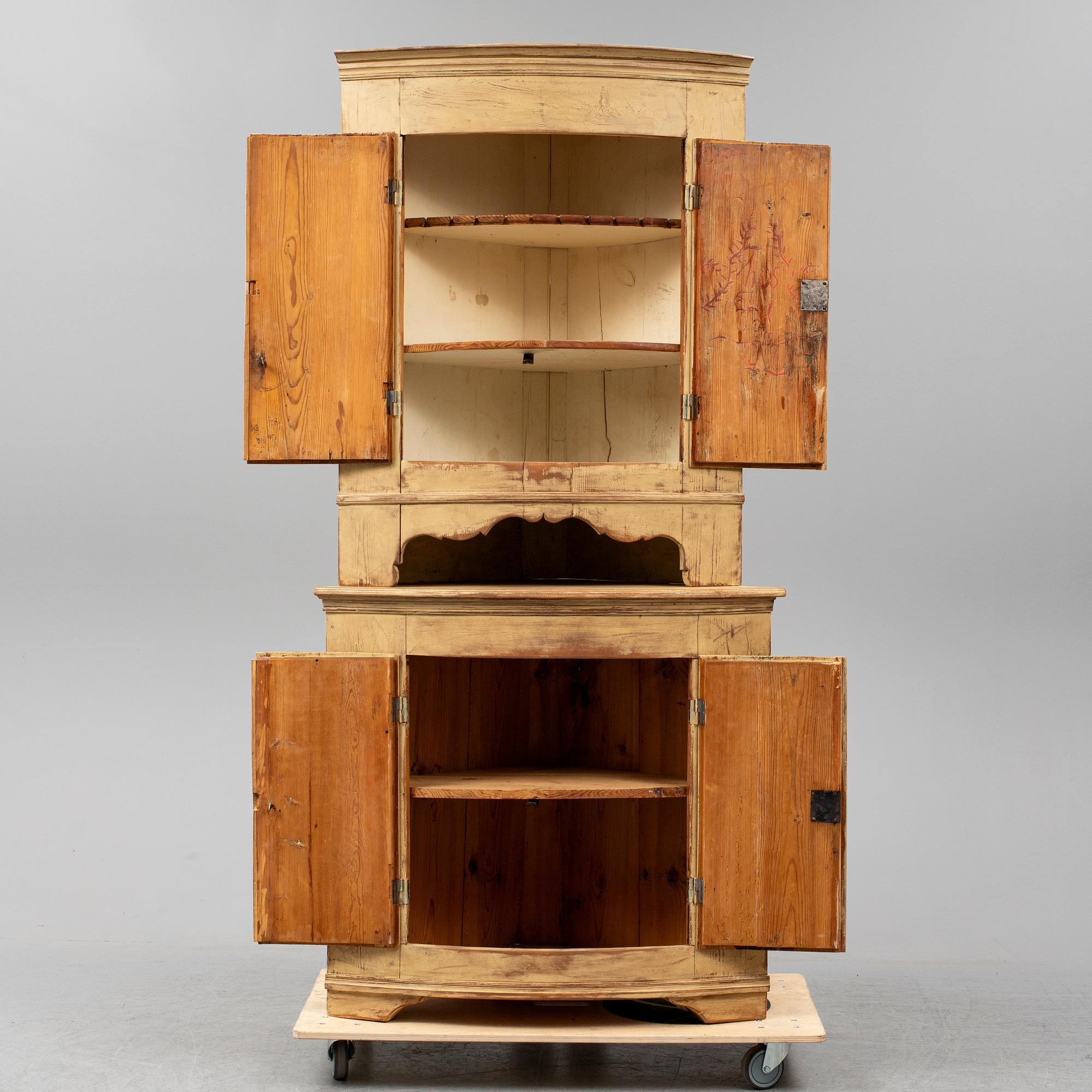 A Swedish late Gustavian corner cabinet in two parts.