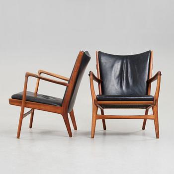 Hans J. Wegner, a pair of "AP16" teak and black leather armchairs, AP-stolen, Denmark 1950-60´s.