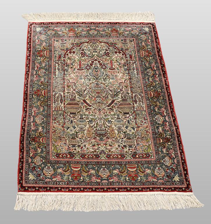 An oriental silk rug, c. 109 x 76 cm.